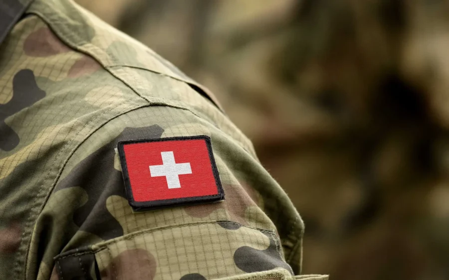 Flag of Switzerland on military uniform. Swiss flag on soldiers arm. Armed Forces, Army. Collage.