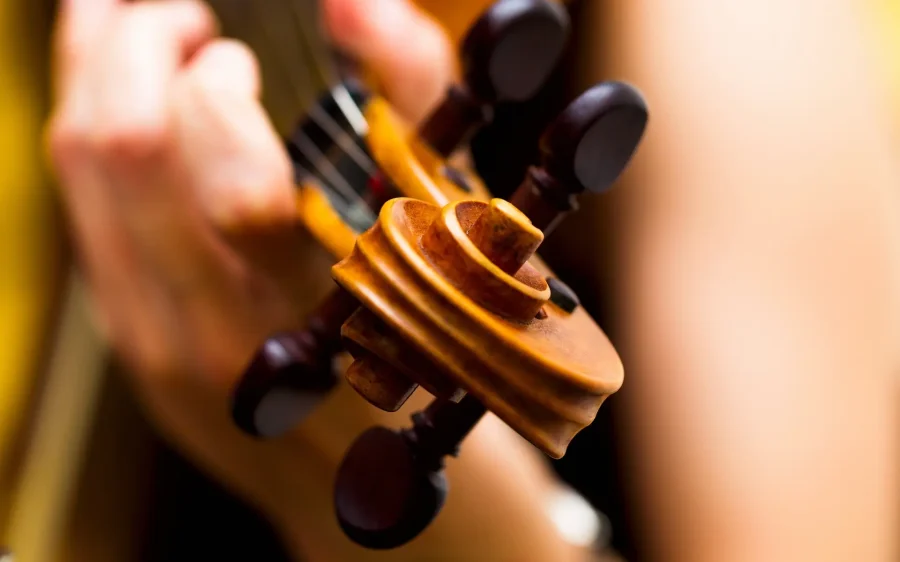 Girl playing the violin classical music concert